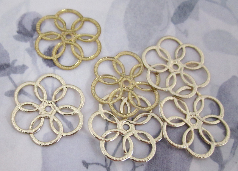 6 pcs. gold tone flexible plastic flower charms 27mm at Pitula The Jeweler